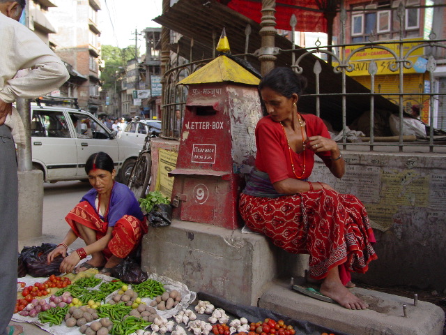 Two women who set up their vegetable shop in from of a letter-box on the street.  This was the norm for vegetable sales in kathmandu