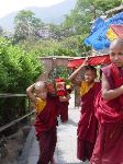 Young monks bringing books up the hill to the monastery