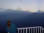 Quinn readies for a photo as the sun readies to rise.  That is Annapurna Machhapuchhre and others in the photo