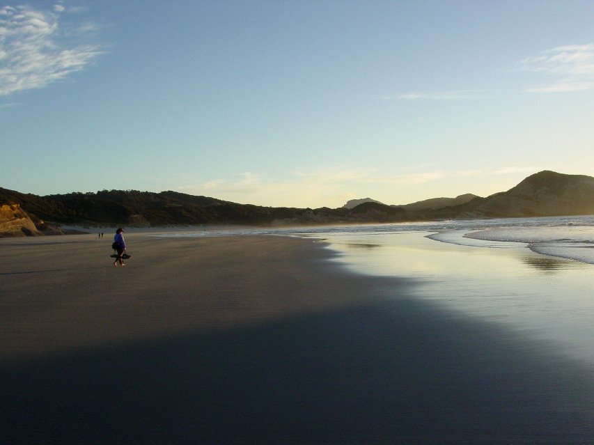 Mother strolls the pristine beach